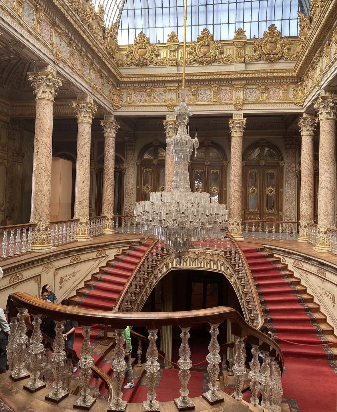 Grand ceremonial hall interior of Dolmabahçe Palace with crystal chandelier and ornate decor