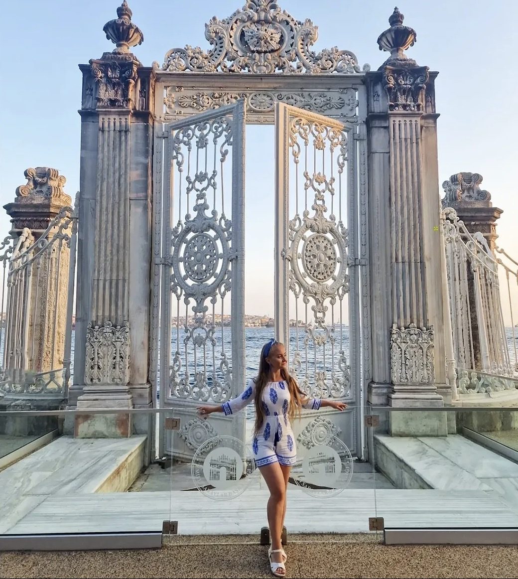 Tourist exploring ornate Dolmabahçe Palace interior wearing comfortable shoes and overshoe covers